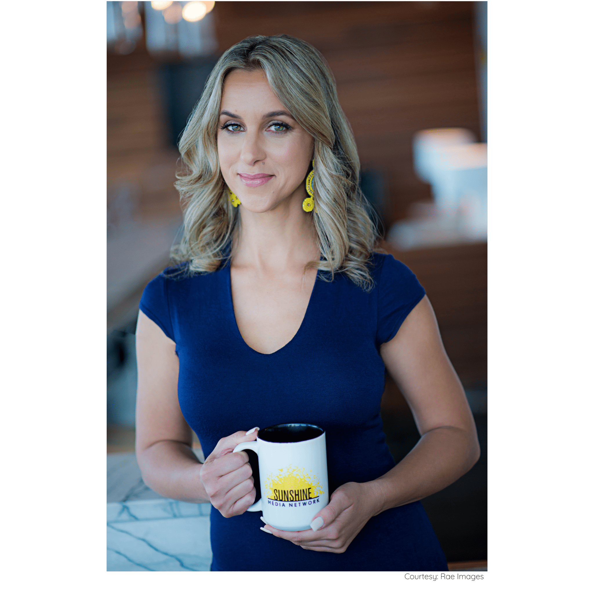 Jennifer Moxley, owner of Sunshine Media Network holding a mug with the Sunshine Media Network logo