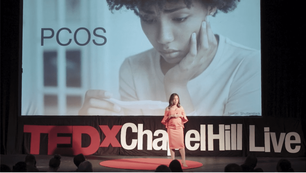 Nichelle Sublett, on stage with the Ted Chapel Hill logo behind her